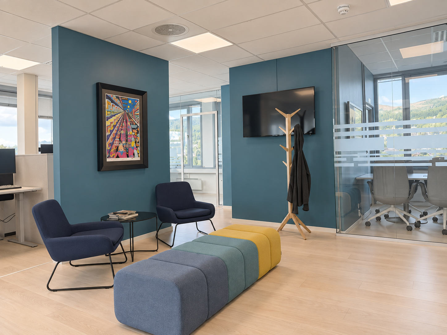 The AiAx office with teal walls, seating and a meeting room